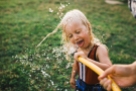 young girl drinks from the hose